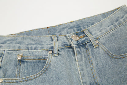 Jean vintage bleu à écusson croisé en forme de cœur chromé