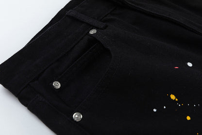 JEAN NOIR À PÂTE EN CROIX JAUNE ET CŒURS CHROMÉS