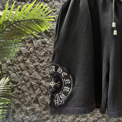 Short noir à broderies blanches et cœurs chromés