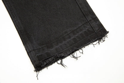 Jean noir à motif cœurs chromés et croix.