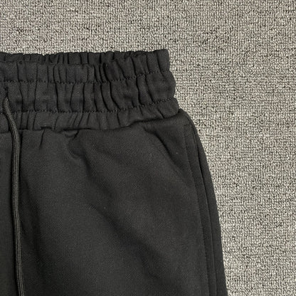 Pantalon de survêtement noir en coton déchiré et couronne