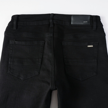 Jean déchiré à patchs noirs Amr