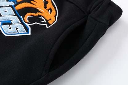 Pantalon noir et orange de tireur